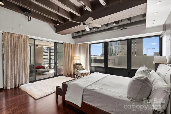 a bedroom with a large bed and a large window