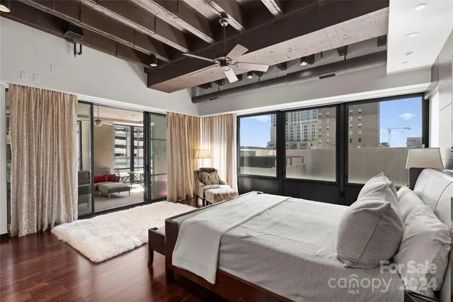 a bedroom with a large bed and a large window