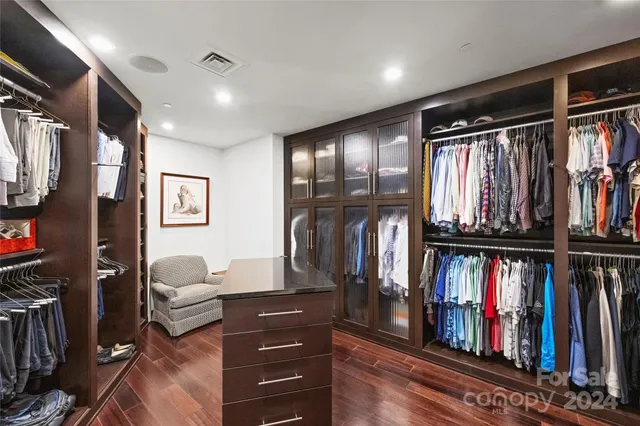 a view of walk in closet with clothes and shoes