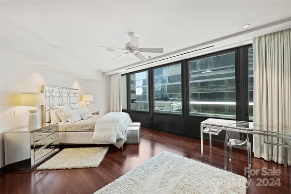 a bedroom with furniture and a large window