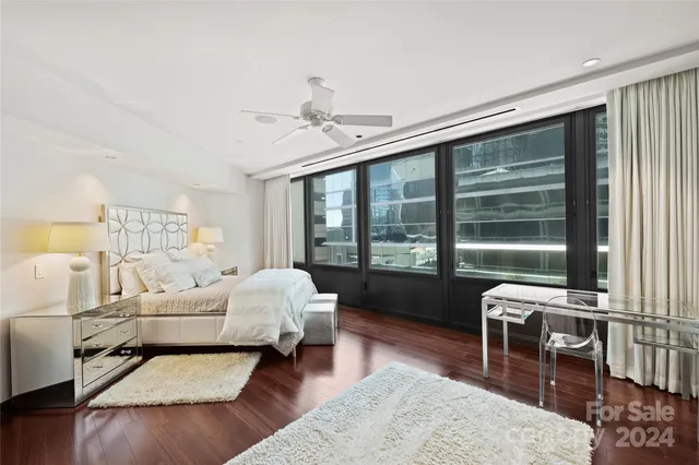 a bedroom with furniture and a large window