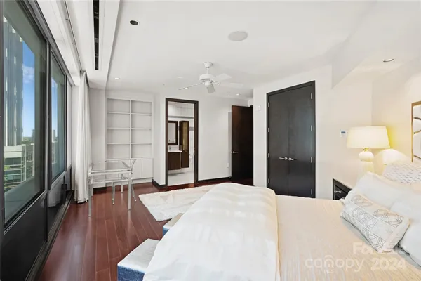 a bedroom with a bed and wooden floor