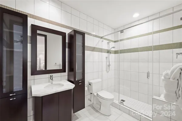 a bathroom with a sink shower and a toilet