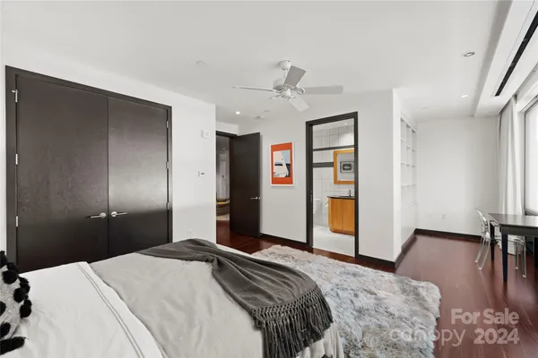 a bedroom with a bed and a large mirror