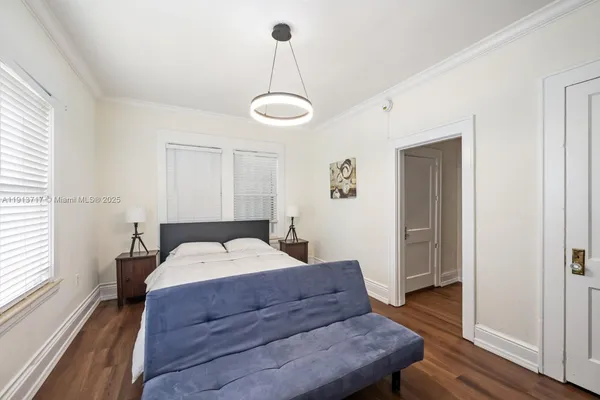 a bed room with a bed and a chandelier