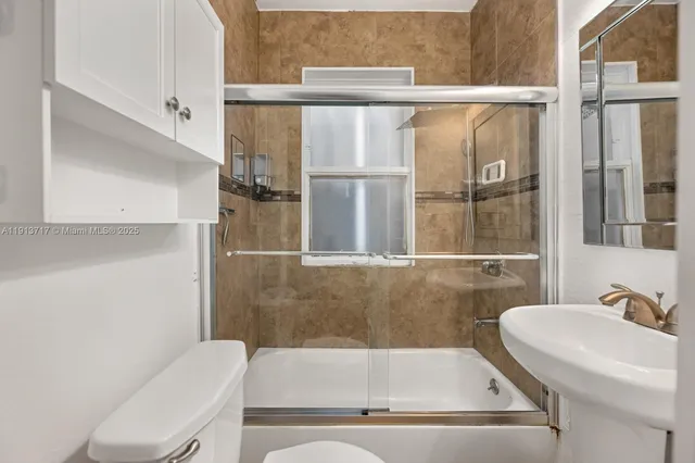 a bathroom with a tub sink and toilet
