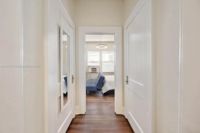 a view of bedroom with wooden floor