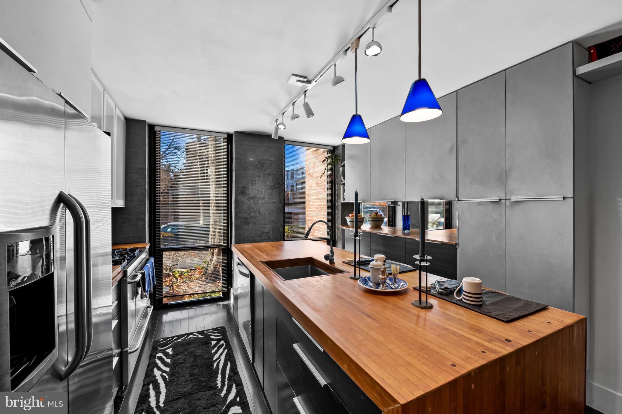 1407 Jordan Street Baltimore, MD 21217 - Photo 14 of 75 a kitchen with stainless steel appliances kitchen island granite countertop a sink and cabinets