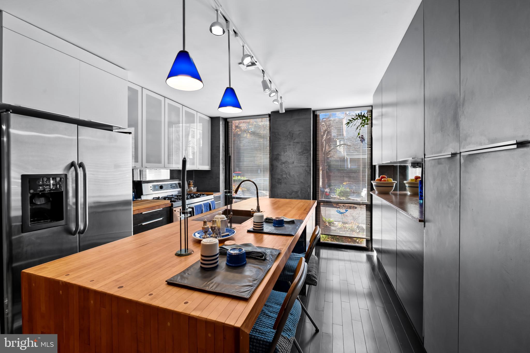 1407 Jordan Street Baltimore, MD 21217 - Photo 16 of 75 a kitchen with stainless steel appliances granite countertop a refrigerator a stove and white cabinets