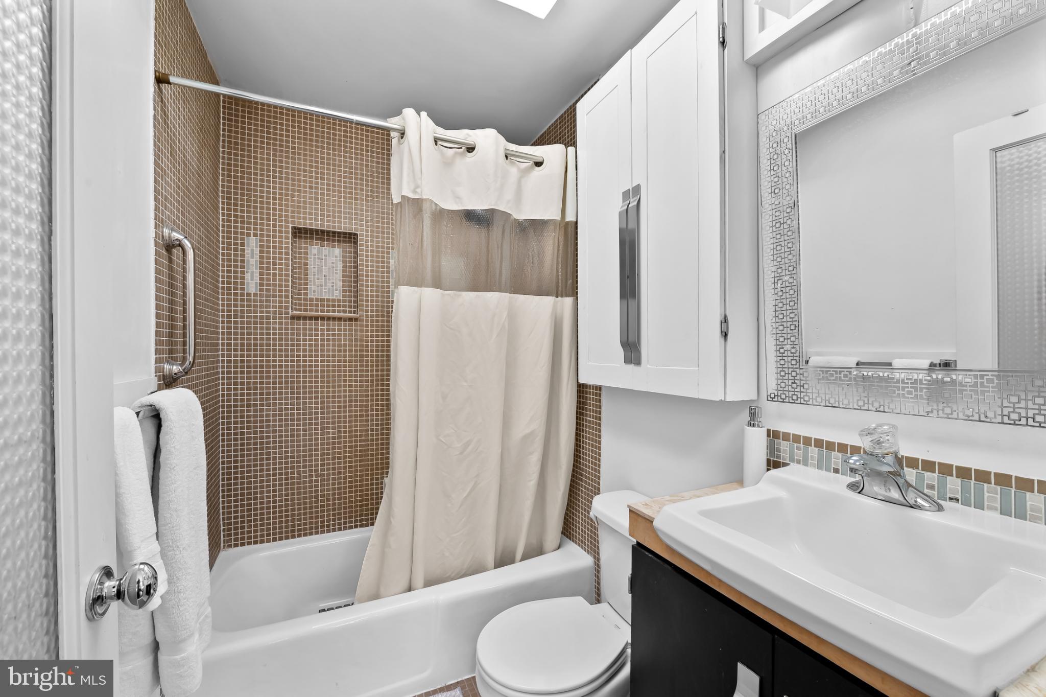 1407 Jordan Street Baltimore, MD 21217 - Photo 40 of 75 a bathroom with a sink toilet and shower