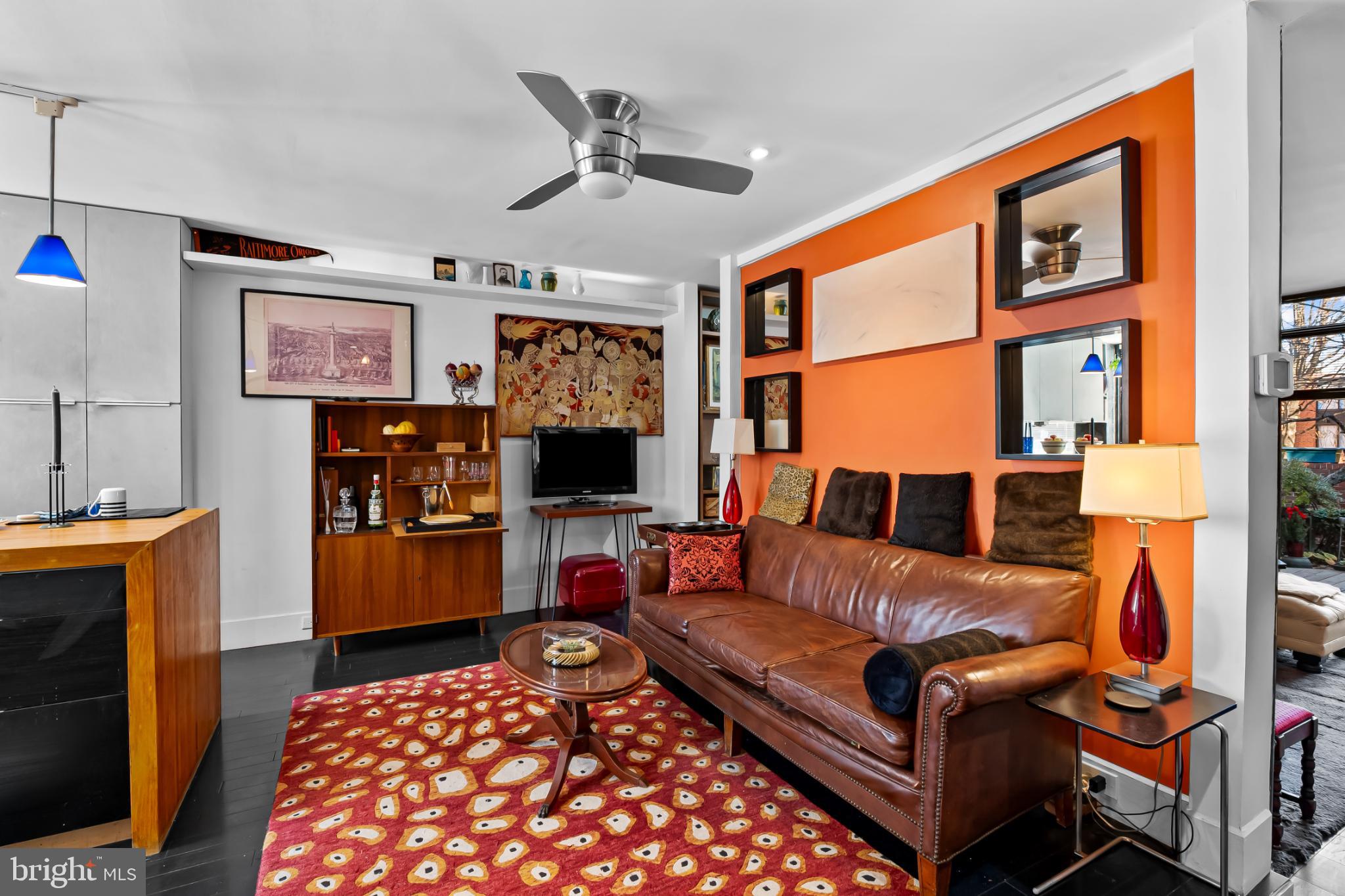 1407 Jordan Street Baltimore, MD 21217 - Photo 6 of 75 a living room with furniture a flat screen tv and a table
