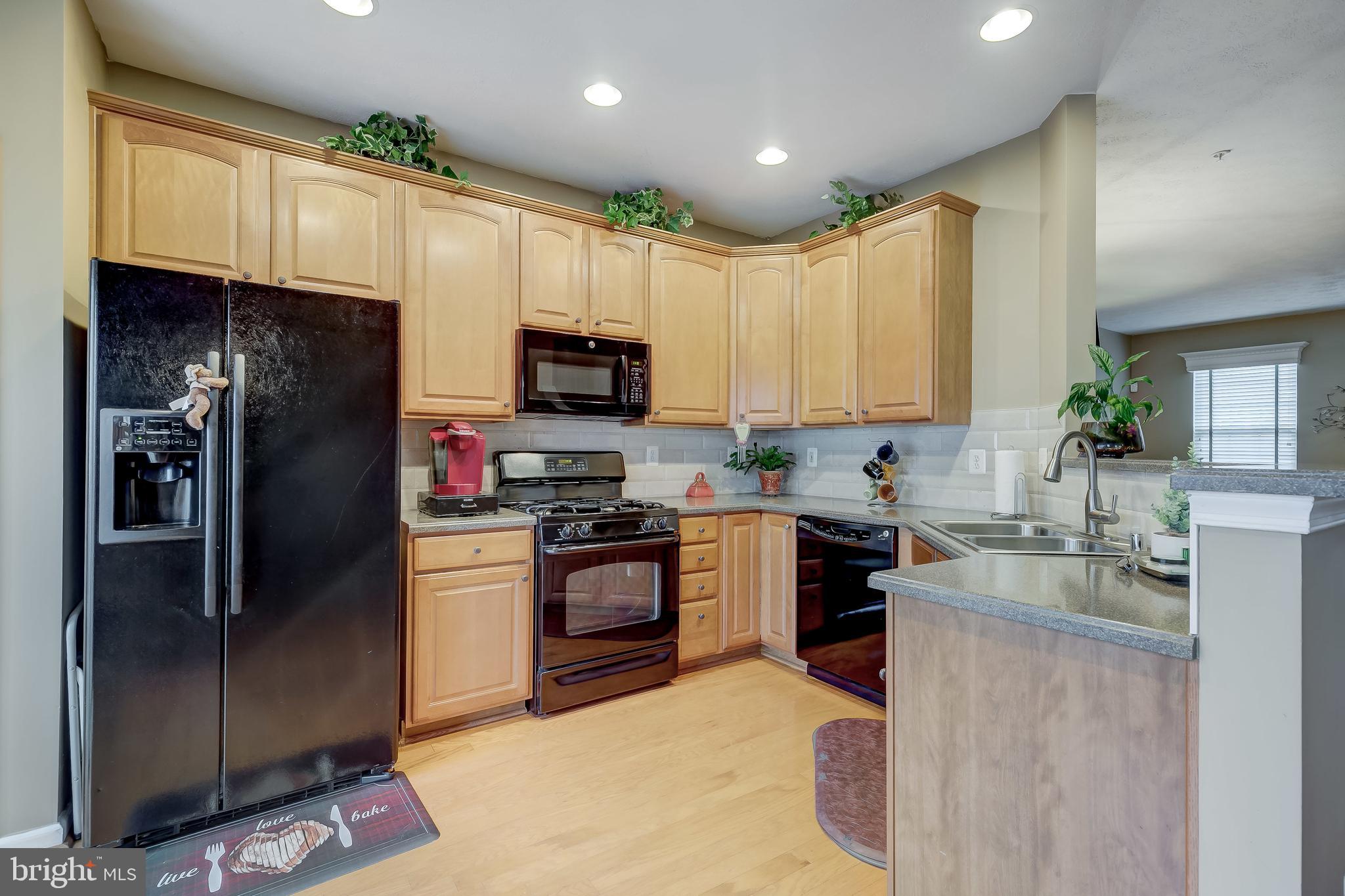 9727 Biggs Road Baltimore, MD 21220 - Photo 14 of 35 a kitchen with stainless steel appliances granite countertop a refrigerator a stove top oven a sink and dishwasher