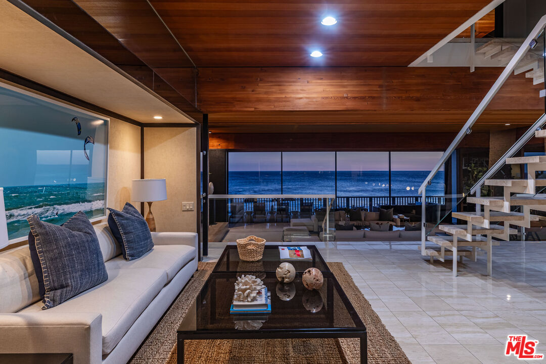 25002 Malibu Road Malibu, CA 90265 - Photo 55 of 60 a room with lots of chairs and a chandelier