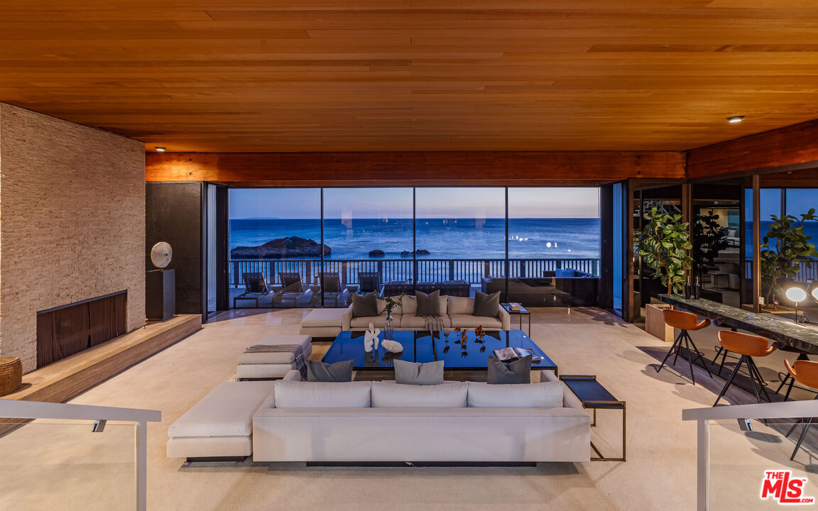 25002 Malibu Road Malibu, CA 90265 - Photo 56 of 60 a bed room with furniture and a fireplace