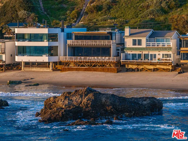 a balcony with chairs and ocean view