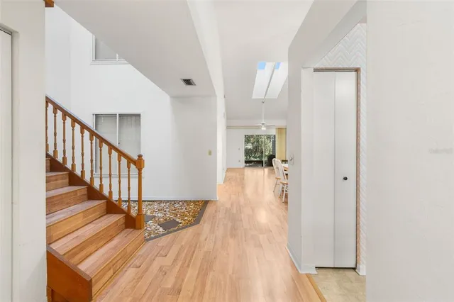 a view of a hallway with wooden floor and staircase