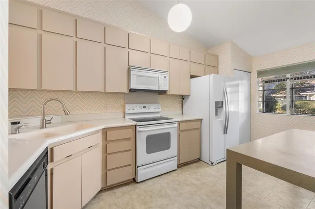 a kitchen with stainless steel appliances a refrigerator sink and cabinets