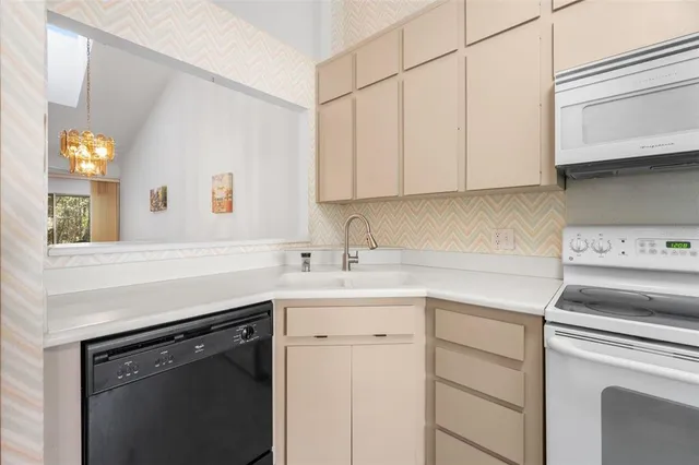 a kitchen with appliances cabinets and a sink