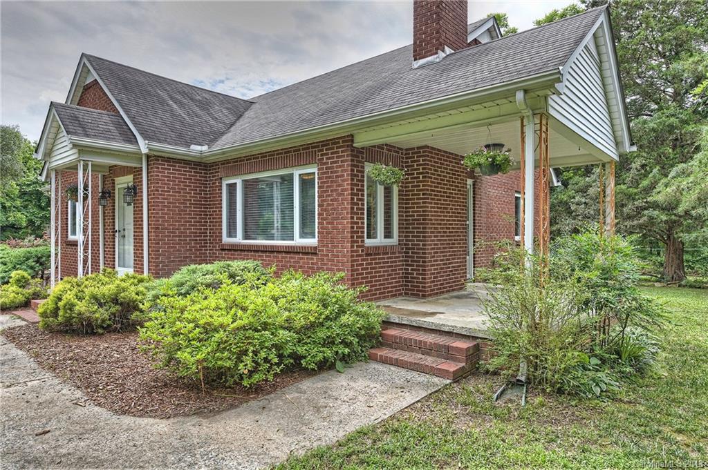 4917 Morgan Mill Road Monroe, NC 28110 - Photo 2 of 36 a front view of a house with garden