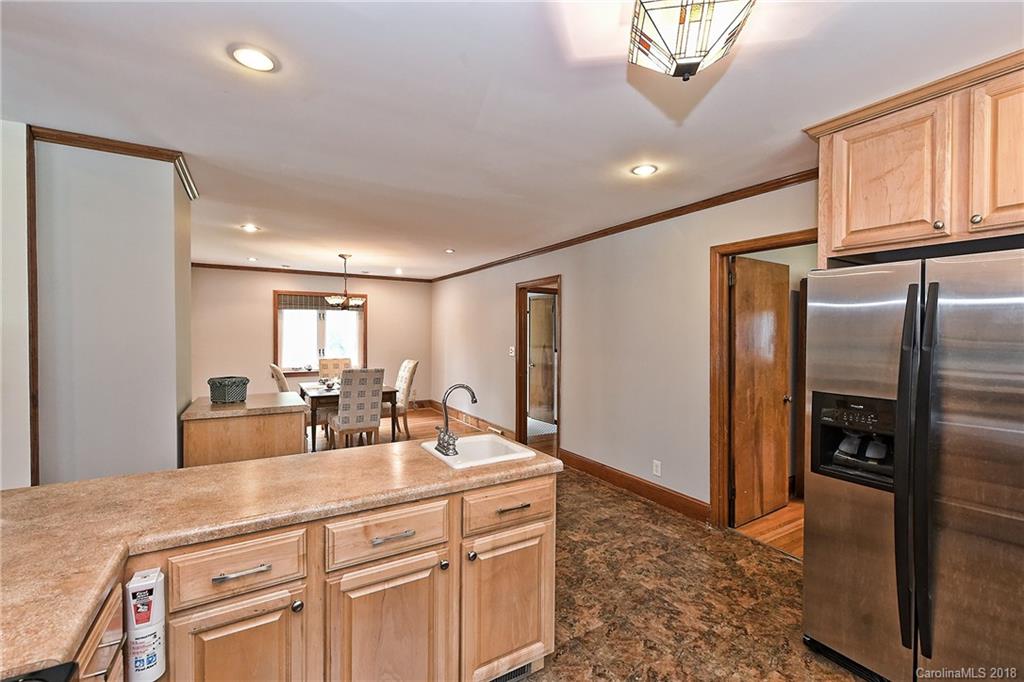 4917 Morgan Mill Road Monroe, NC 28110 - Photo 14 of 36 a room with stainless steel appliances a sink a refrigerator and cabinets