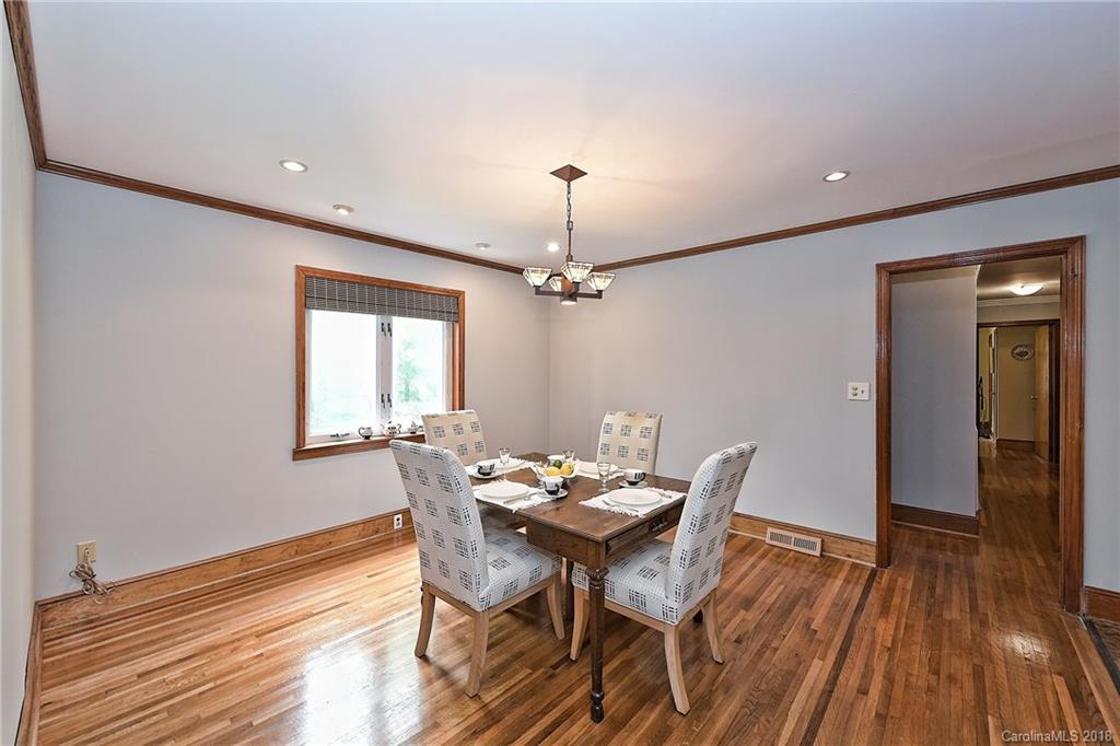 4917 Morgan Mill Road Monroe, NC 28110 - Photo 17 of 36 a view of a dining room with furniture wooden floor and chandelier