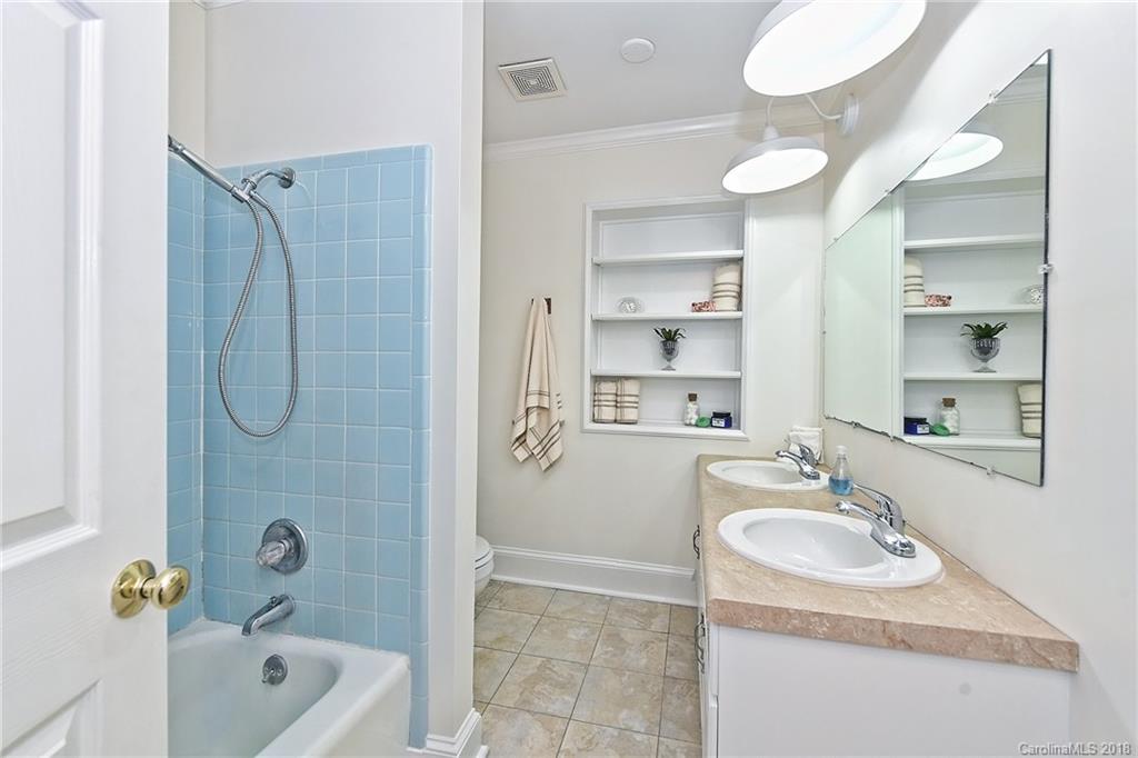 4917 Morgan Mill Road Monroe, NC 28110 - Photo 26 of 36 a bathroom with a granite countertop sink a mirror a bathtub and shower