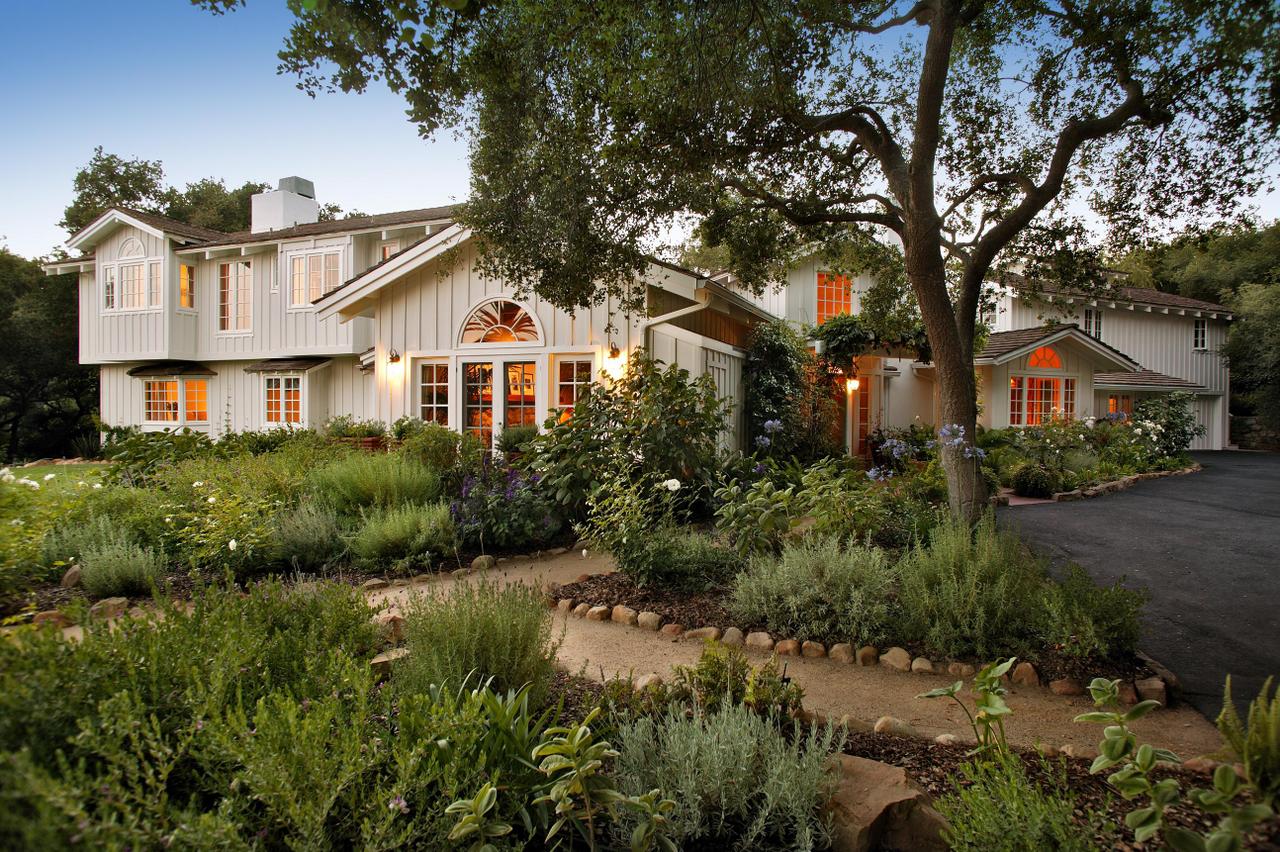 655 Parra Grande Lane Montecito, CA 93108 - Photo 2 of 8 a front view of a house with a yard and potted plants