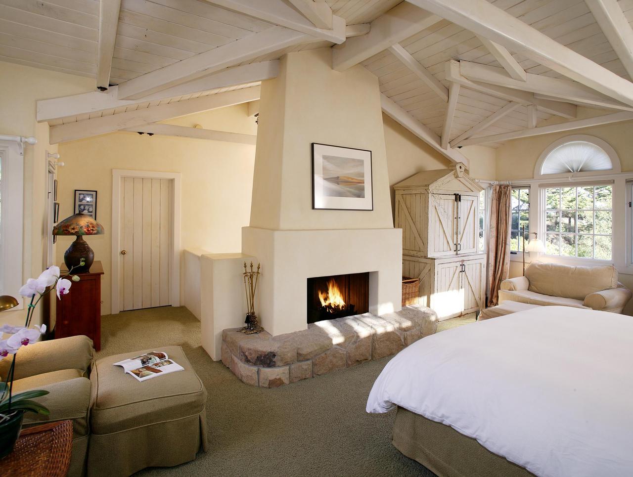 655 Parra Grande Lane Montecito, CA 93108 - Photo 6 of 8 a bedroom with furniture and a fireplace