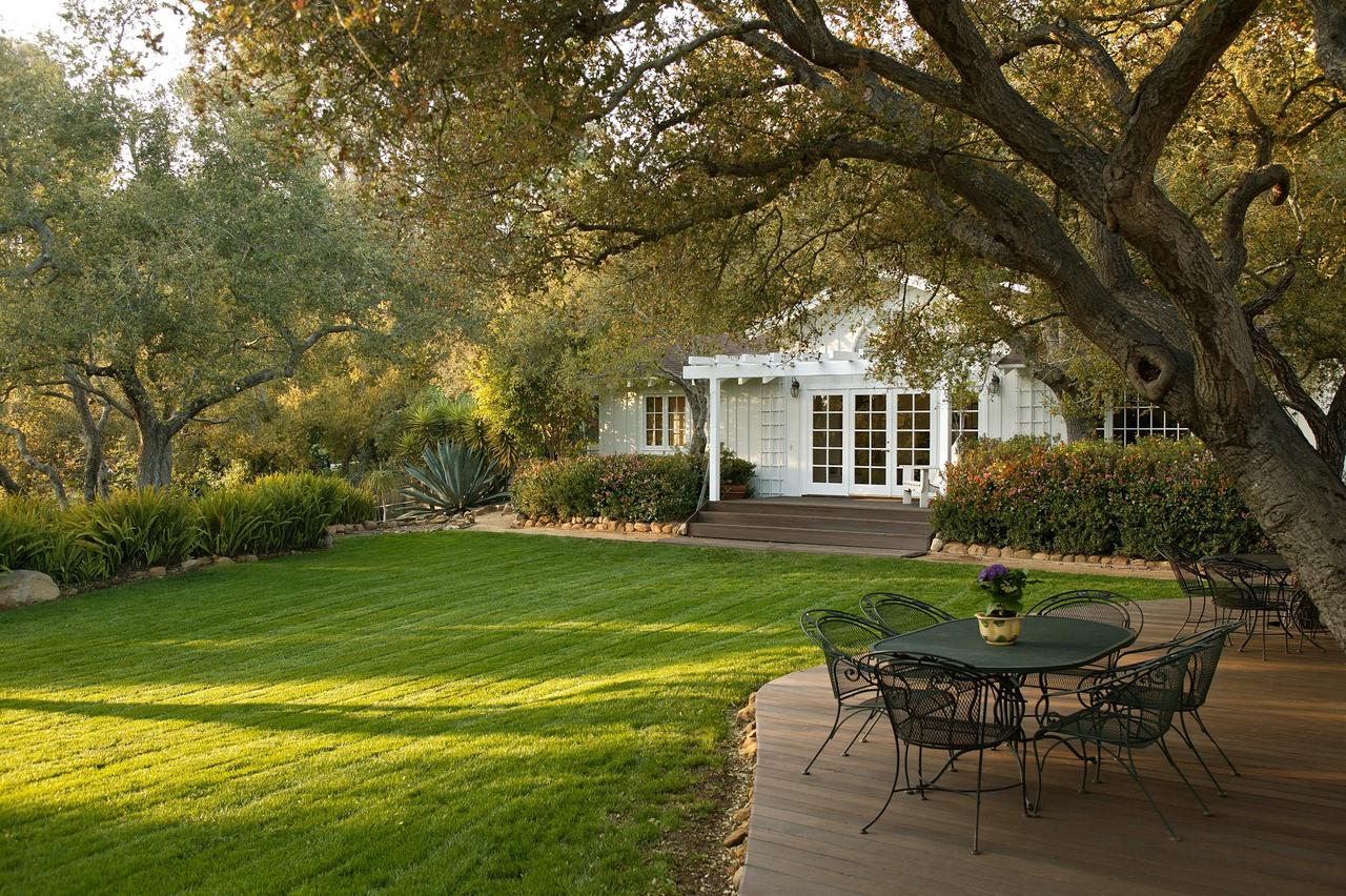 655 Parra Grande Lane Montecito, CA 93108 - Photo 8 of 8 a front view of a house with a yard table and chairs