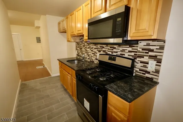 a kitchen with stainless steel appliances a stove a microwave sink and cabinets