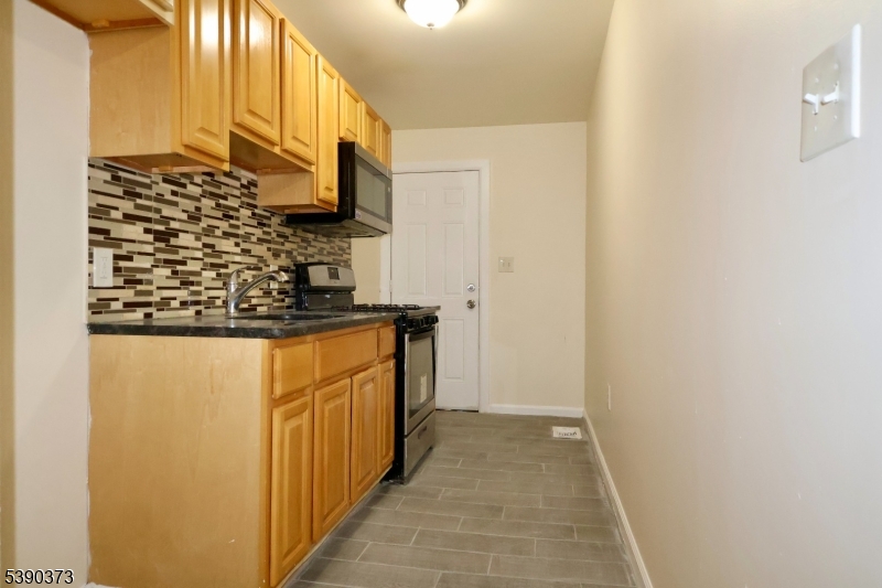 89 Cutler Street, Unit 1 Newark, NJ 07104 - Photo 2 of 13 a bathroom with a sink and a mirror