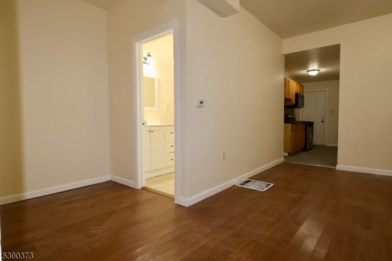 89 Cutler Street, Unit 1 Newark, NJ 07104 - Photo 4 of 13 an empty room with a bathroom and a sink