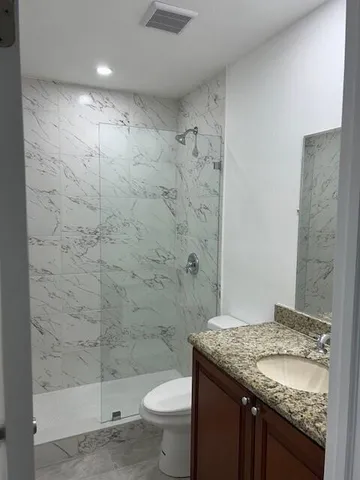 a view of a small space with wooden floor and a window