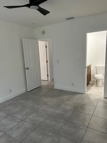 a white toilet next to a bathroom shower