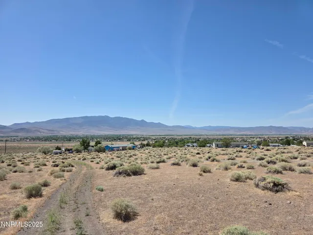 a view of mountain with wooden fence