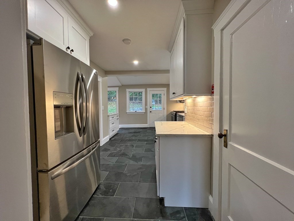 10 Governor Road Arlington, MA 02474 - Photo 11 of 22 a kitchen with stainless steel appliances a refrigerator and a sink