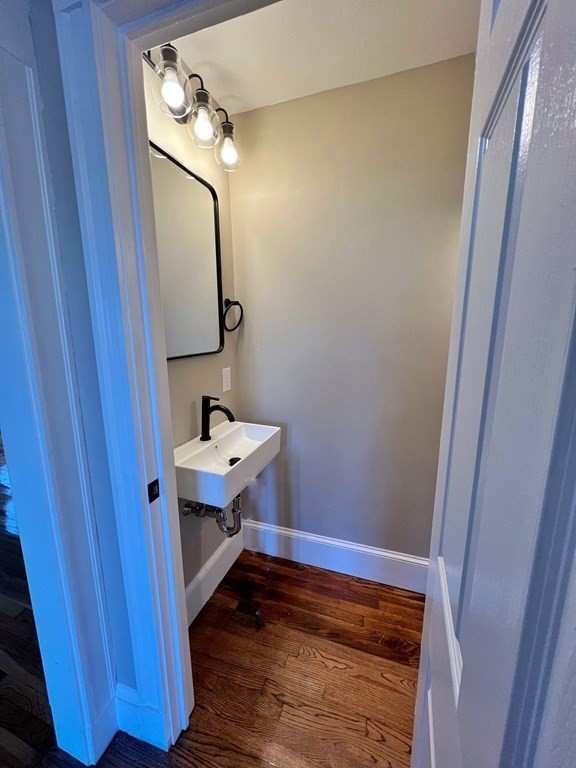 10 Governor Road Arlington, MA 02474 - Photo 13 of 22 a bathroom with a sink a light fixture and a mirror