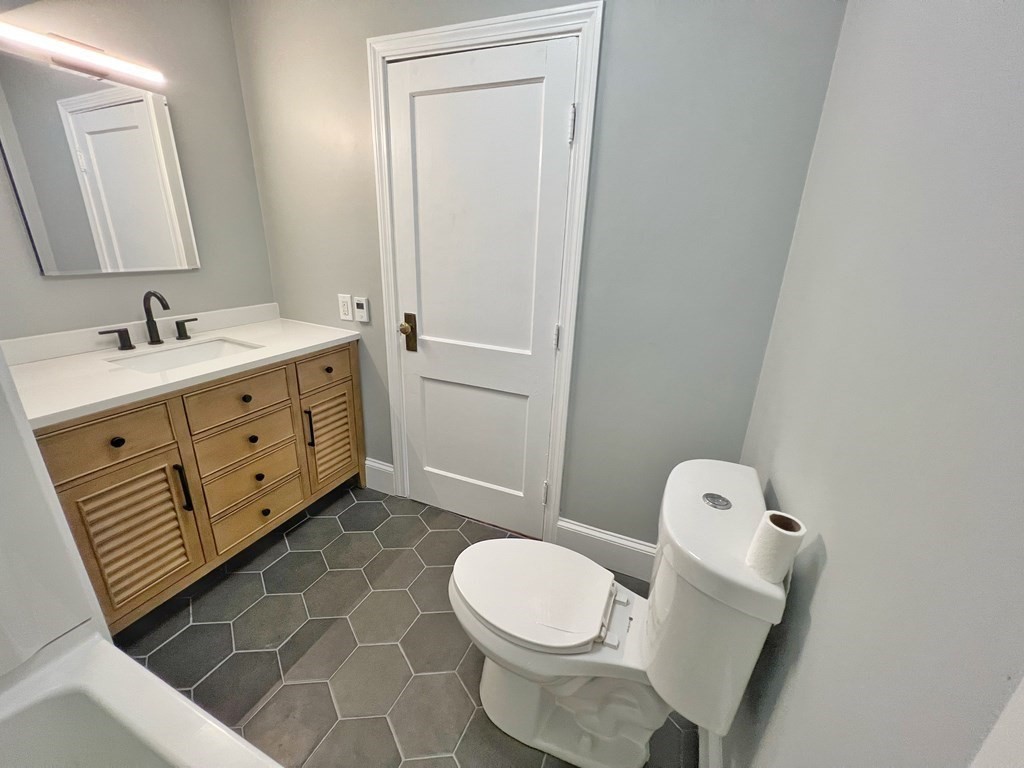 10 Governor Road Arlington, MA 02474 - Photo 19 of 22 a bathroom with a toilet sink and mirror