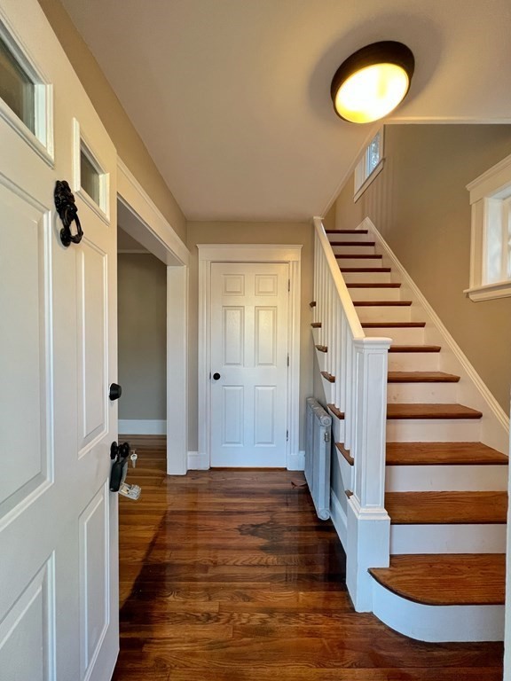 10 Governor Road Arlington, MA 02474 - Photo 3 of 22 a view of a hallway with wooden floor and staircase