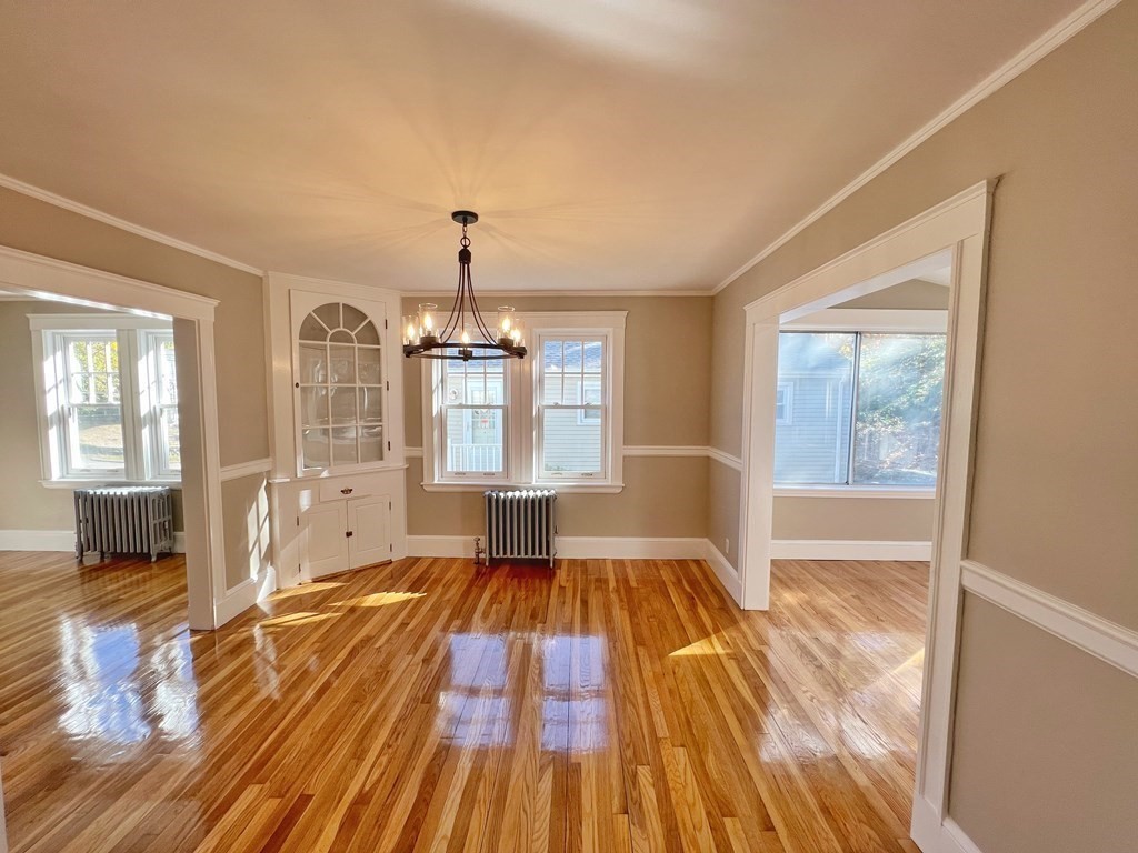 10 Governor Road Arlington, MA 02474 - Photo 7 of 22 a spacious bedroom with a bed and wooden floor