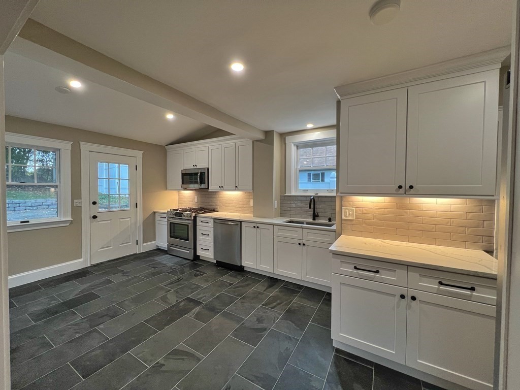 10 Governor Road Arlington, MA 02474 - Photo 9 of 22 a kitchen with stainless steel appliances granite countertop a sink and cabinets