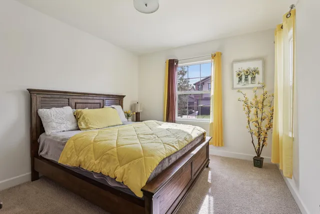 a bathroom with a granite countertop sink mirror vanity and toilet