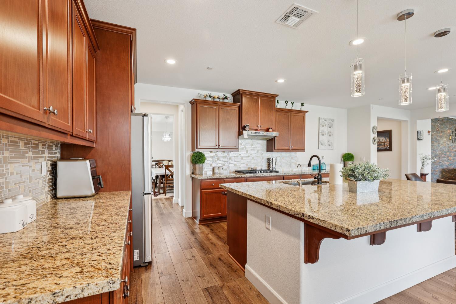 2371 Rio Grande Drive Tracy, CA 95377 - Photo 20 of 61 a kitchen with stainless steel appliances granite countertop counter space and wooden floors