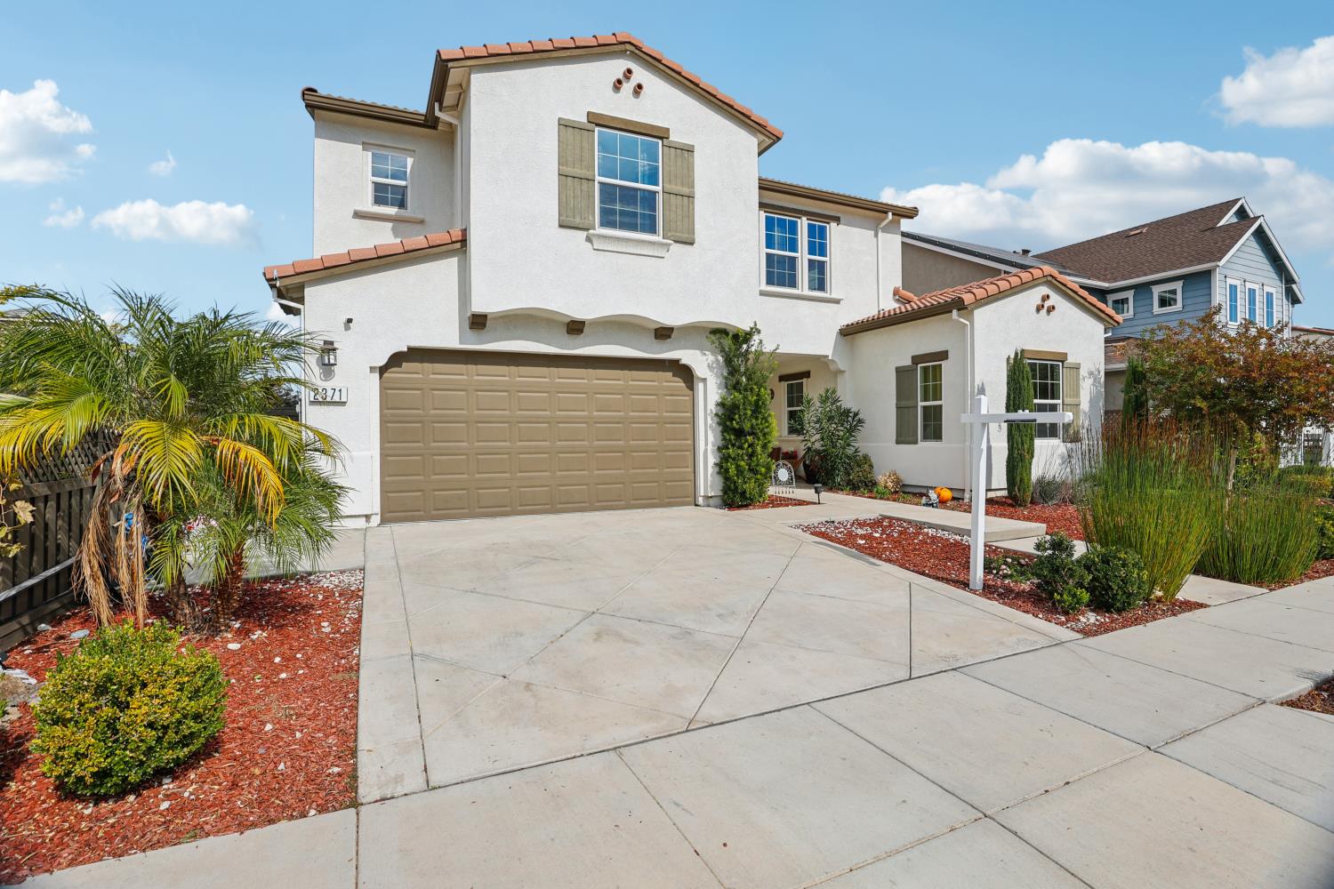 2371 Rio Grande Drive Tracy, CA 95377 - Photo 2 of 61 a front view of a house with a yard and potted plants
