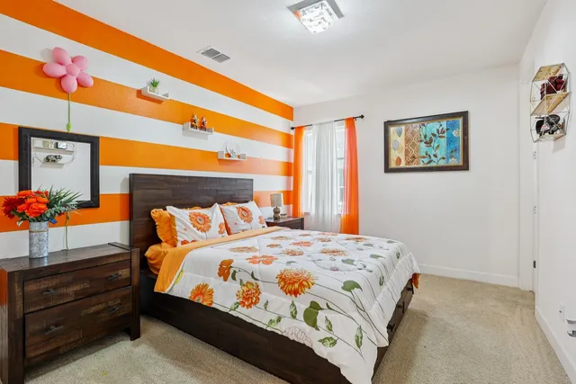 a bedroom with furniture and a window