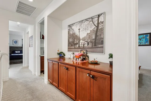 a large kitchen with stainless steel appliances kitchen island granite countertop a refrigerator and a sink