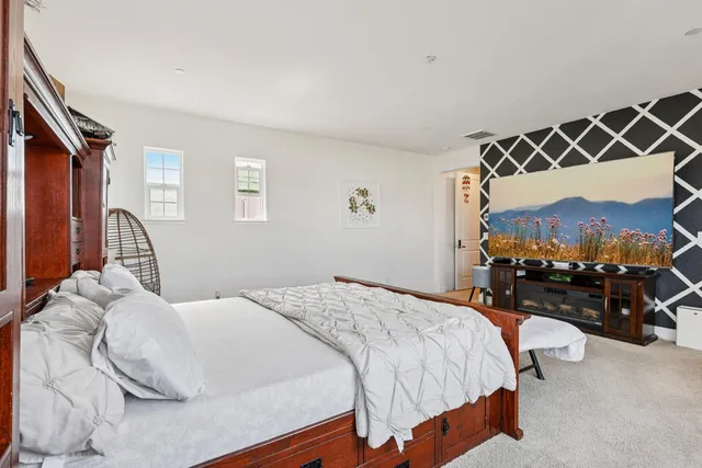 a large white kitchen with a sink and cabinets