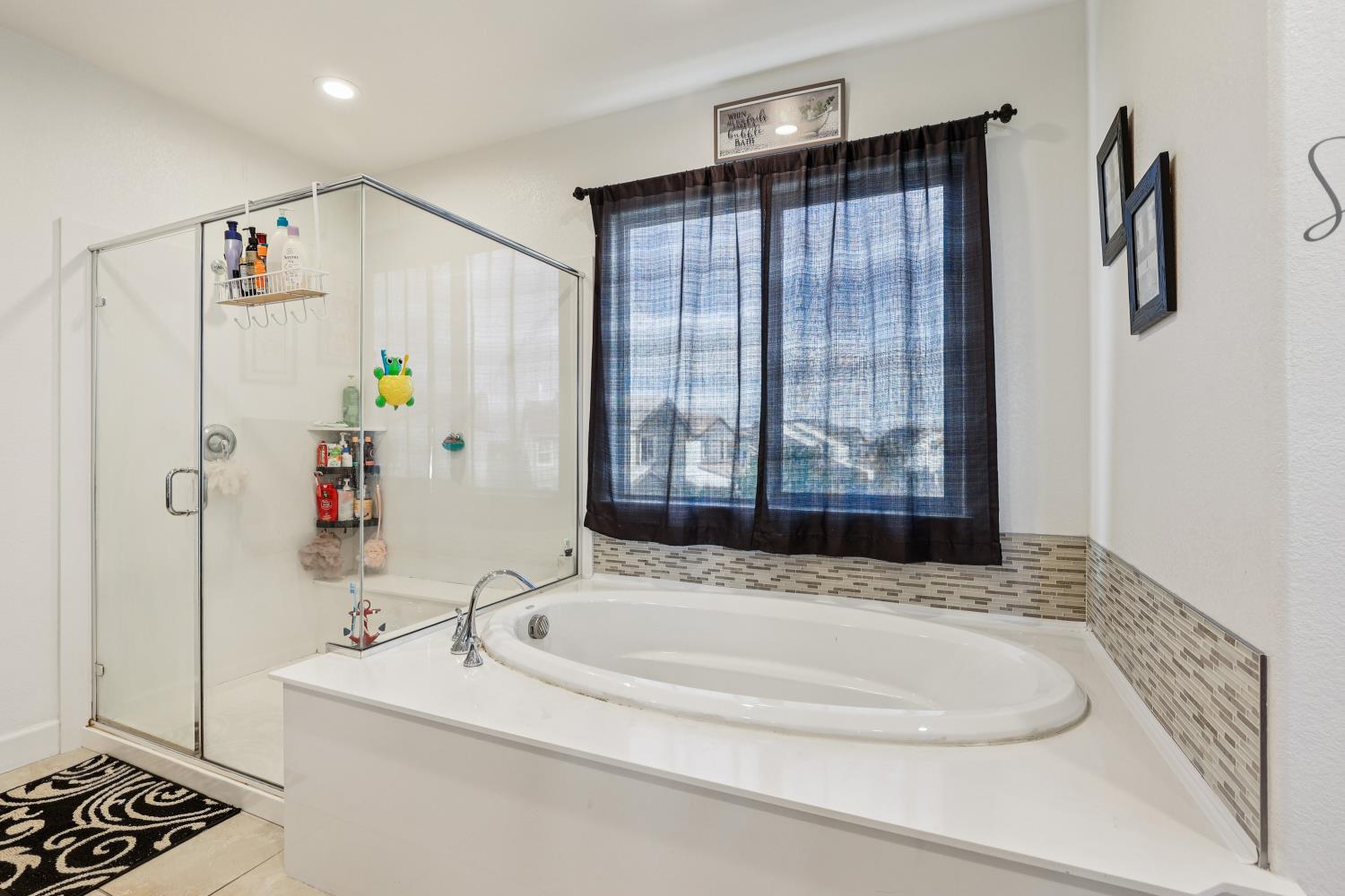 2371 Rio Grande Drive Tracy, CA 95377 - Photo 42 of 61 a bathroom with a bathtub and a shower