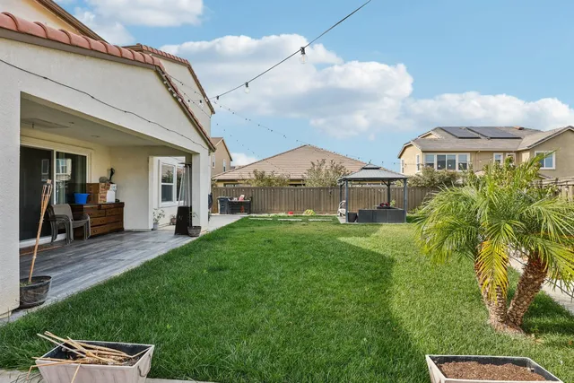 an aerial view of ocean and residential houses with outdoor space