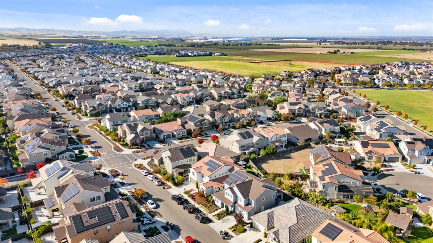 2371 Rio Grande Drive Tracy, CA 95377 - Photo 58 of 61 an aerial view of a city with lots of residential buildings and ocean view in back